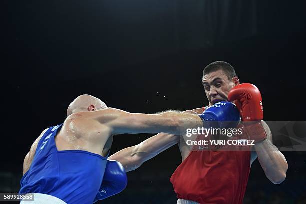 Russia's Evgeny Tishchenko fights Kazakhstan's Vassiliy Levit during the Men's Heavy Final Bout match at the Rio 2016 Olympic Games at the Riocentro...