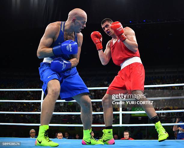 Russia's Evgeny Tishchenko fights Kazakhstan's Vassiliy Levit during the Men's Heavy Final Bout match at the Rio 2016 Olympic Games at the Riocentro...