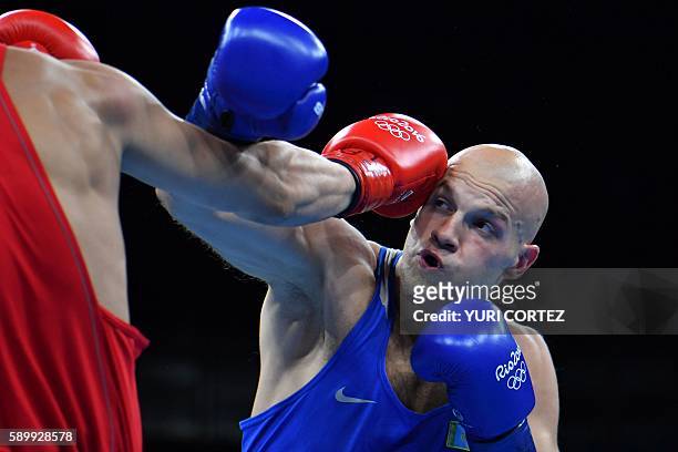 Russia's Evgeny Tishchenko fights Kazakhstan's Vassiliy Levit during the Men's Heavy Final Bout match at the Rio 2016 Olympic Games at the Riocentro...