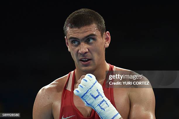 Russia's Evgeny Tishchenko reacts to winning against Kazakhstan's Vassiliy Levit during the Men's Heavy Final Bout match at the Rio 2016 Olympic...