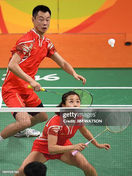 China's Xu Chen and China's Ma Jin return to Malaysia's Peng Soon Chan and Malaysia's Liu Ying Goh during their mixed doubles semi-final badminton...