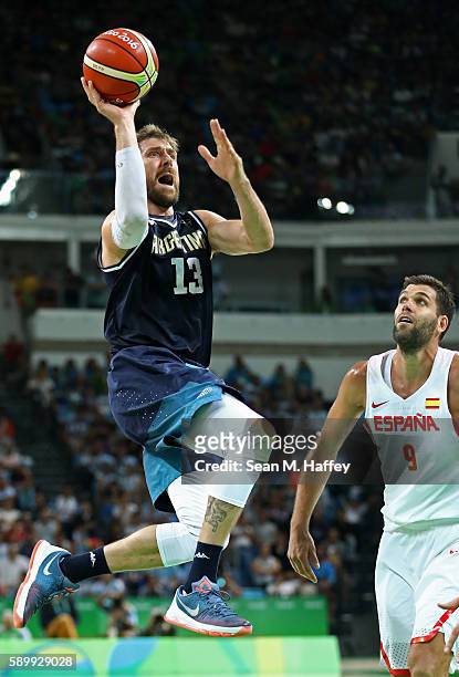 Andres Nocioni of Argentina shoots against Felipe Reyes of Spain during a Men's Basketball Preliminary Round Group B game between Spain and Argentina...
