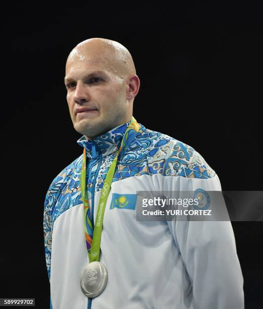Kazakhstan's Vassiliy Levit poses on the podium with a medal following a boxing match at the Rio 2016 Olympic Games at the Riocentro - Pavilion 6 in...
