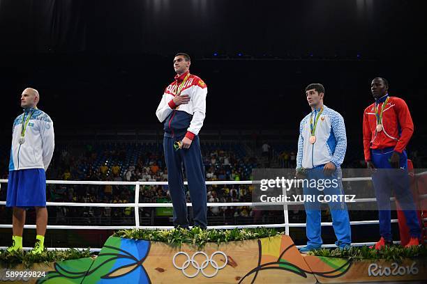 Kazakhstan's Vassiliy Levit, Russia's Evgeny Tishchenko, Uzbekistan's Rustam Tulaganov and Cuba's Erislandy Savon pose on the podium with their...