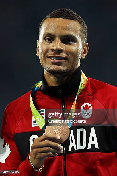 Bronze medalist Andre de Grasse of Canada poses on the podium during the medal ceremony for the Mens 100 metres on Day 10 of the Rio 2016 Olympic...