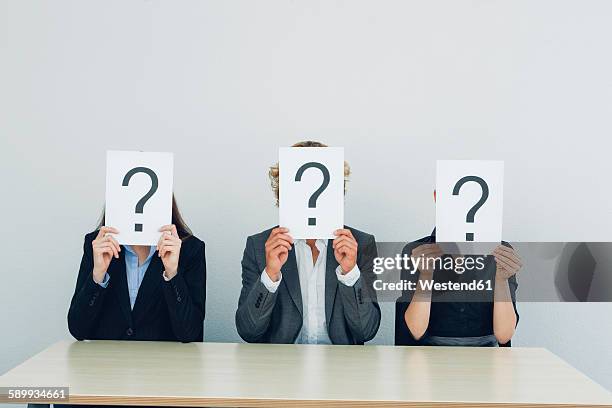 business people with question mark on placards - fragen stock-fotos und bilder