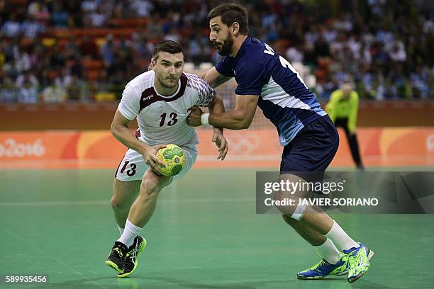 Qatar's right wing Eldar Memisevic vies with Argentina's right back Federico Vieyra during the men's preliminaries Group A handball match Qatar vs...