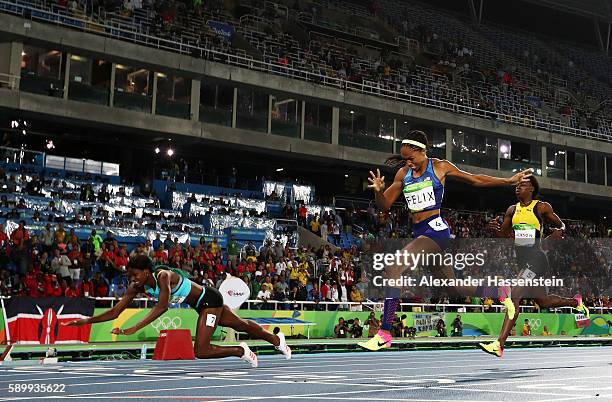 Shaunae Miller of the Bahamas dives over the finish line to win the gold medal in the Women's 400m Final ahead of silver medalist Allyson Felix of...