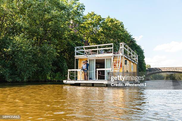 couple having a trip on a house boat - hausboot stock-fotos und bilder