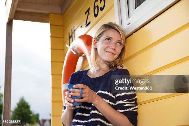 releaxed woman on a house boat with coffee cup - hausboot stock-fotos und bilder