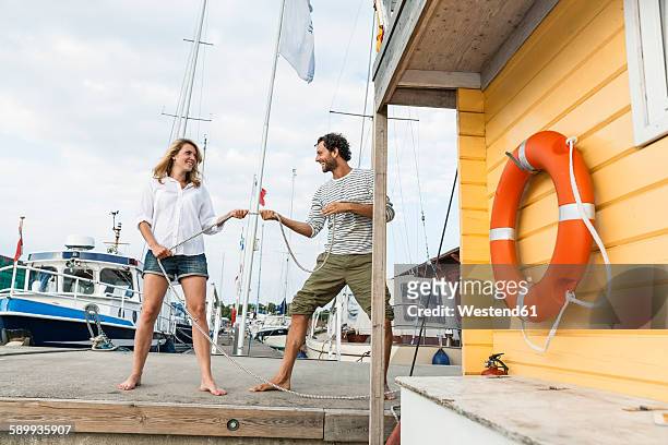 couple mooring house boat at pier - vertäut stock-fotos und bilder