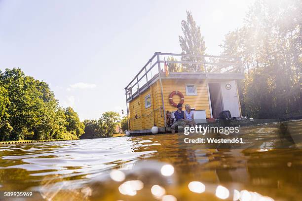 couple having a trip on a house boat - houseboat stock pictures, royalty-free photos & images