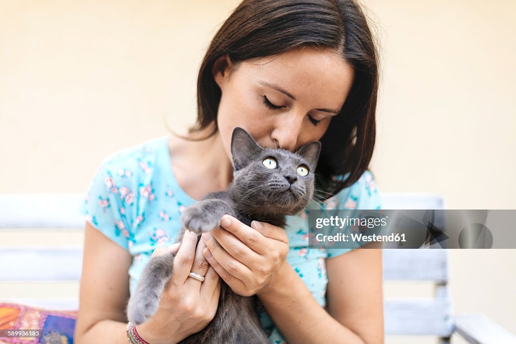 Woman kissing Russian Blue