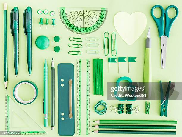 green office supplies on green background - tidy stock-fotos und bilder