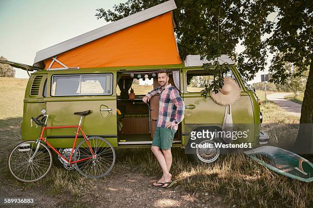 smiling man in front of van in the nature - north rhine westphalia foto e immagini stock