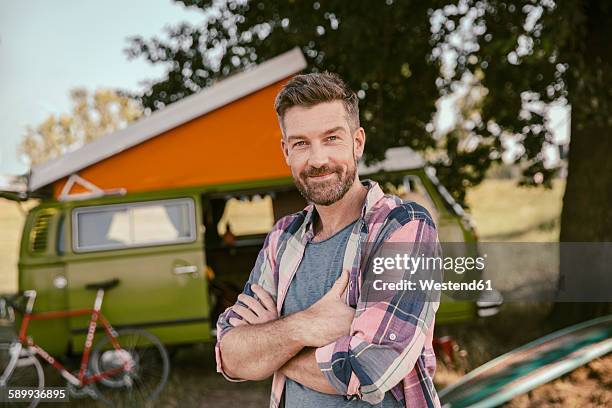 smiling man in front of van in the nature - portrait of a camper stock pictures, royalty-free photos & images