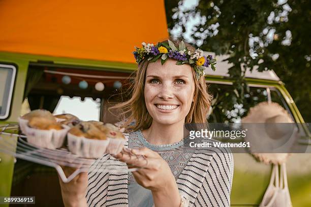 hippie woman presenting vegan muffins in front of van - hippie bildbanksfoton och bilder
