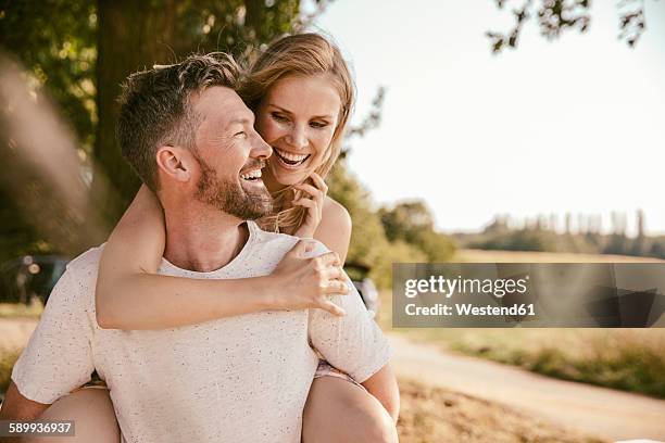 carefree couple in the nature - couple laughing stock-fotos und bilder