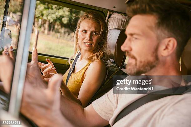 couple arguing in van on a road trip - conflict stockfoto's en -beelden