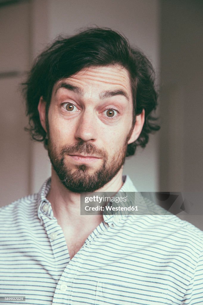 Bearded man looking at camera with a surprised expression