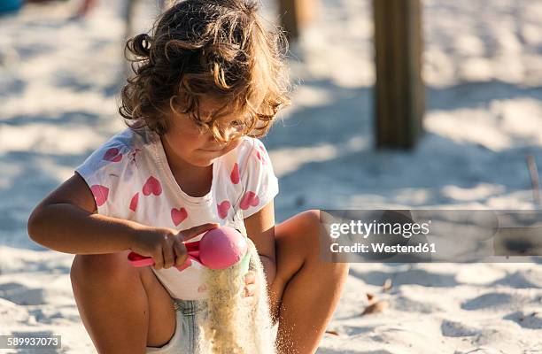 little girl playing in sandbox on playground - 2 kid in a sandbox fotografías e imágenes de stock