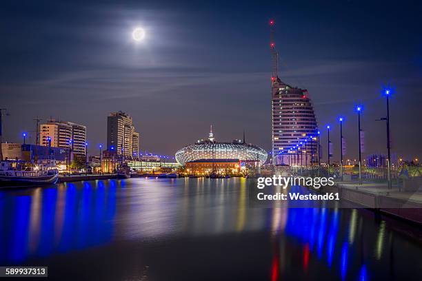 germany, bremerhaven, klimahaus and atlantic hotel sail city at night - bremerhaven stock-fotos und bilder