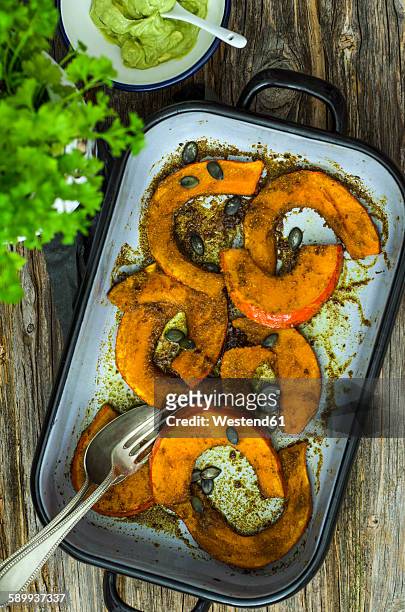 baked slices of pumpkin and bowl of avocado dip - hokaido pumpkin stock pictures, royalty-free photos & images