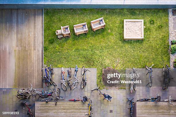germany, berlin, view onto backyard with playground and bikes - sandkasten stock-fotos und bilder