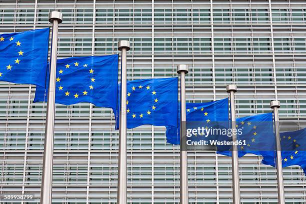 belgium, brussels, european commission, european flags at berlaymont building - european commission stock-fotos und bilder