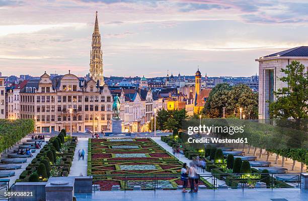 belgium, brussels, mont des arts, park and townhall tower, lower city in the evening - brussels stock-fotos und bilder