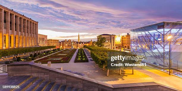 belgium, brussels, mont des arts, congress center square, glass cube, park and townhall towerand lower city in the evening - brussels square stock-fotos und bilder