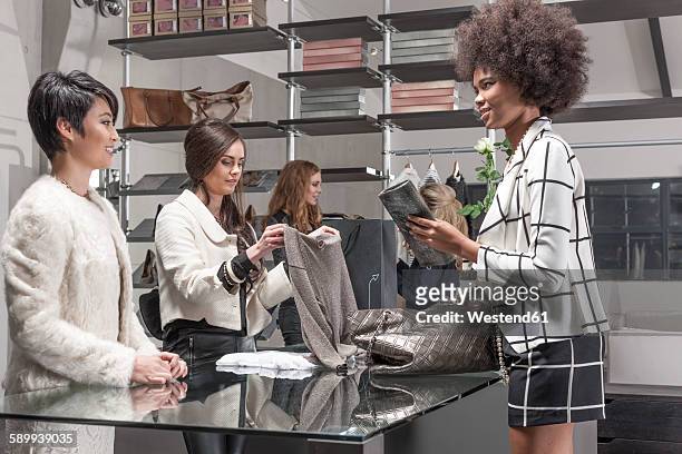 woman shopping in luxury boutique - luxury handbag stock pictures, royalty-free photos & images