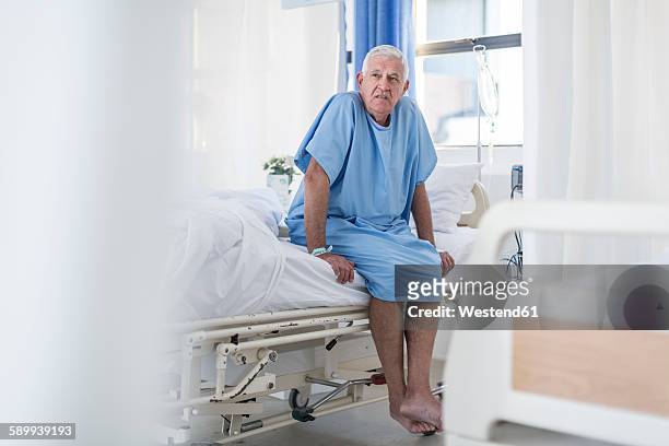 senior patient sitting on hospital bed - hospital gown stock pictures, royalty-free photos & images
