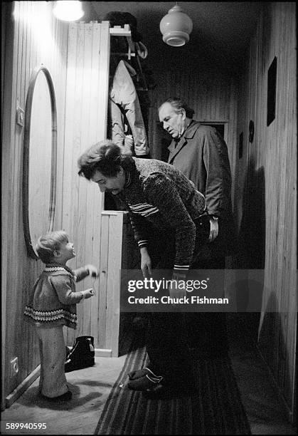 As he puts on his shoes, Polish trade-unionist Lech Walesa talks with one of his sons , Jaroslaw, before leaving for work, Gdansk, Poland, December...