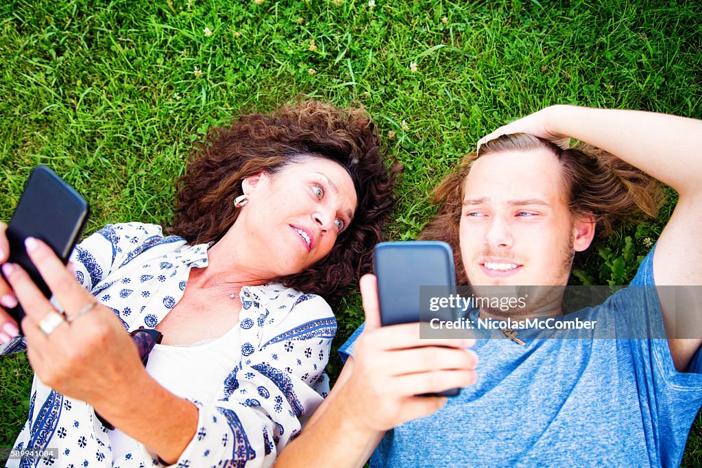 Teenage son unimpressed at mother handling mobile phone