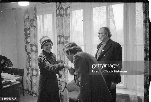 In his office at Solidarity headquarters, Polish trade-unionist Lech Walesa kisses the hand of an unidentified woman visitor, Gdansk, Poland,...