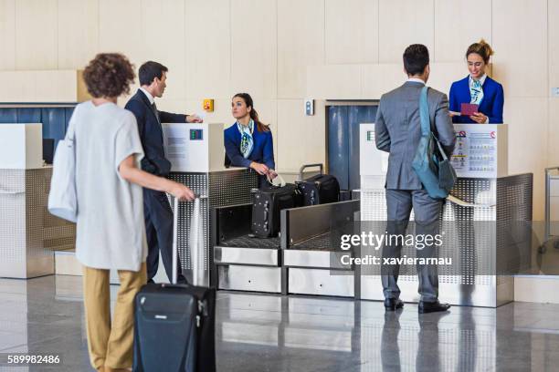 business people checking in at the airport - airport staff stock pictures, royalty-free photos & images