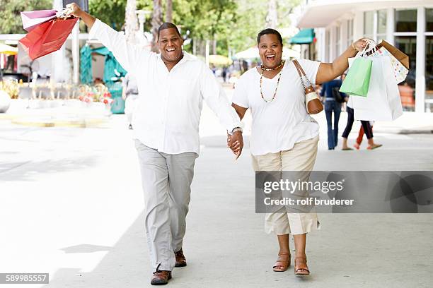 carefree couple shopping - chubby man shopping stock pictures, royalty-free photos & images