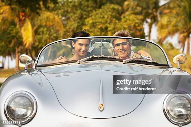 couple on vacation in vintage sports car - man driving sports car stock pictures, royalty-free photos & images