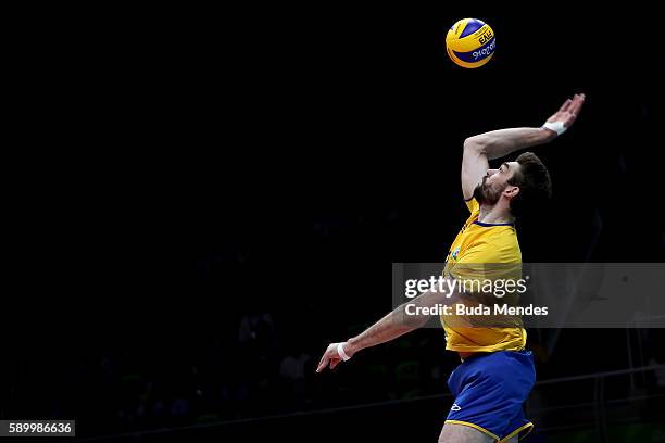 Lucas Saatkamp of Brazil spikes the ball during the men's qualifying volleyball match between Brazil and France on Day 10 of the Rio 2016 Olympic...