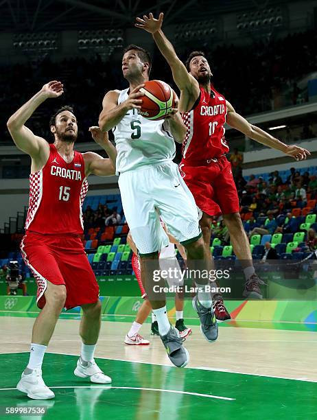 Mantas Kalnietis of Lithuania is challenged by Miro Bilan of Croatia and Roko Ukic of Croatia during a Men's Basketball Preliminary Round Group B...