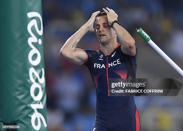 France's Renaud Lavillenie reacts after missing his final jump during the Men's Pole Vault Final during the athletics event at the Rio 2016 Olympic...