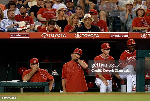 Manager Mike Scioscia, pitching coach Charles Nagy, coaches Ron Roenicke and Alfredo Griffin of the Los Angeles Angels of Anaheim react during the...