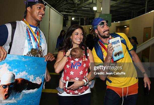 Nicole Johnson, fiancee of Michael Phelps, holding their baby son Boomer Phelps pose with fans of Phelps on day 8 of the Rio 2016 Olympic Games at...