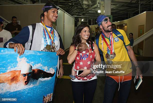 Nicole Johnson, fiancee of Michael Phelps, holding their baby son Boomer Phelps pose with fans of Phelps on day 8 of the Rio 2016 Olympic Games at...