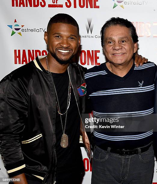 Actor/singer Usher Raymond and former professional boxer Roberto Duran arrive at a screening of the Weinstein Company's "Hands of Stone" at the...