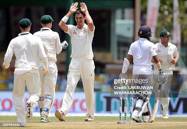 Australia's Mitchell Starc celebrates with teammates after he dismissed Sri Lankan batsman Kusal Mendis during the fourth day of the third and final...