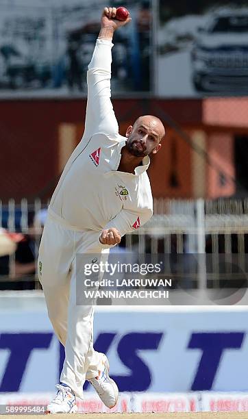 Australia's Nathan Lyon delivers the ball during the fourth day of the third and final Test cricket match between Sri Lanka and Australia at The...