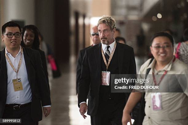 John McAfee , founder of the eponymous anti-virus company, arrives at the China Internet Security Conference in Beijing on August 16, 2016. / AFP /...