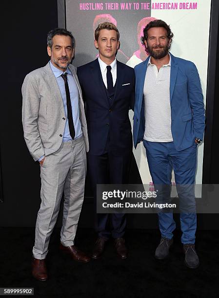 Director Todd Phillips and actors Miles Teller and Bradley Cooper attend the premiere of Warner Bros. Pictures' "War Dogs" at the TCL Chinese Theatre...